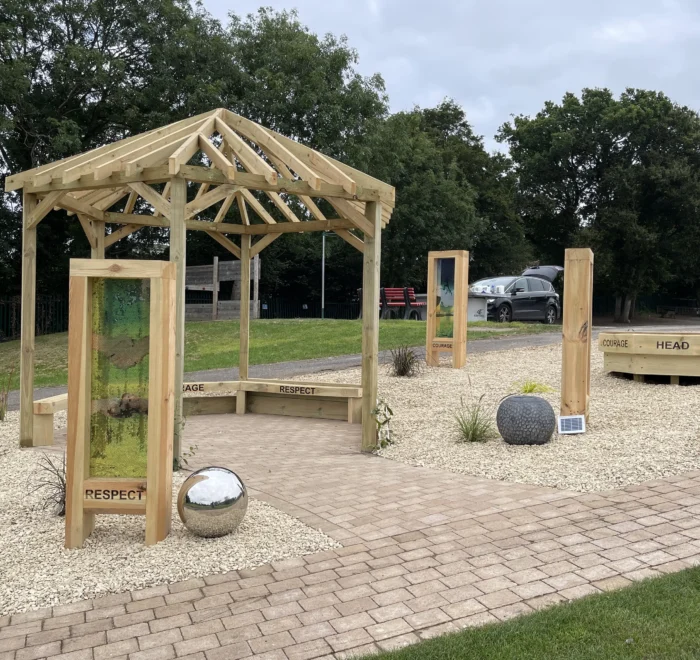 Timber shelter, sensory panels and planting in the Kingsclere Primary outdoor space