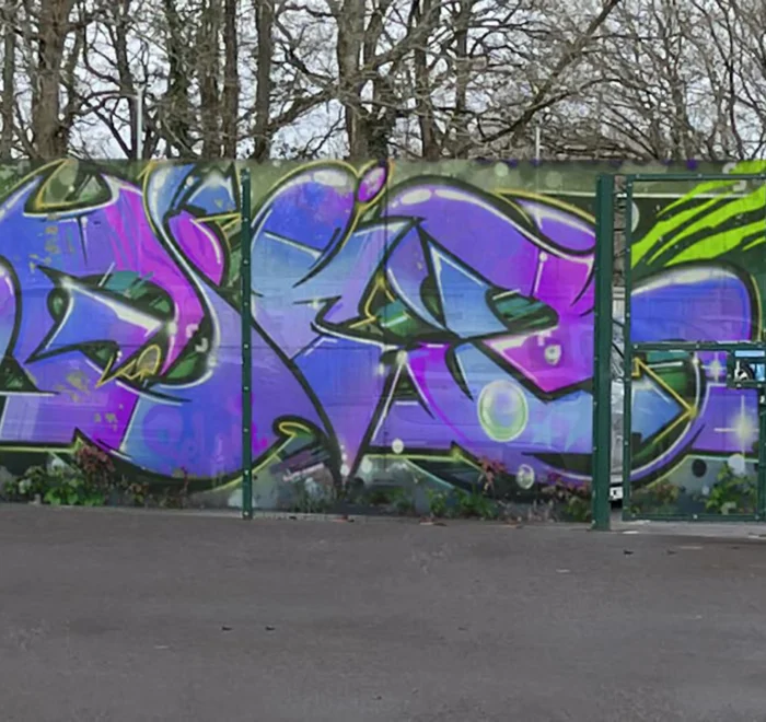 Visualisation of colourful graffiti-style graphics across a playground fence