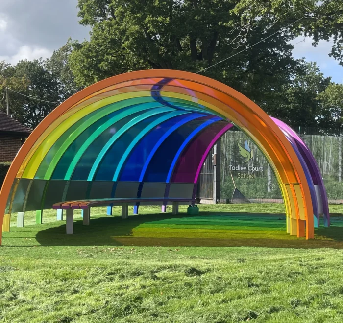 Front view of the completed rainbow-coloured playground shelter